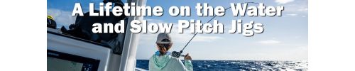 Person standing on a fishing boat using a bent fishing rod to battle a fish over open ocean water, illustrating slow pitch jigging offshore.