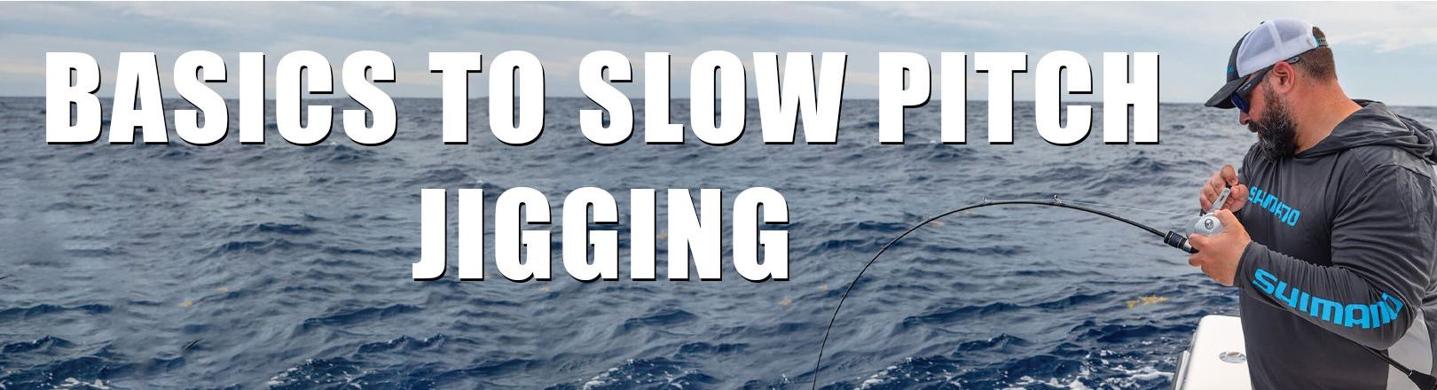 Angler in gray Shimano hoodie with blue lettering and a white and gray cap fishing from a boat using a silver reel and bent rod, performing slow pitch jigging. Overcast sky and open ocean in background. Large bold text reads “BASICS TO SLOW PITCH JIGGING.