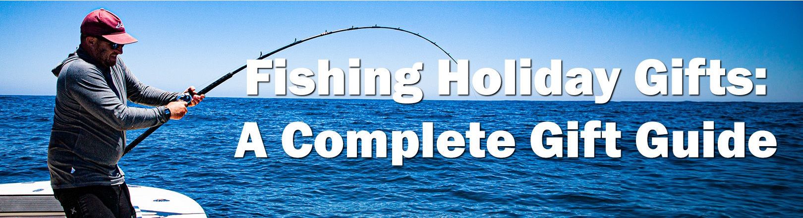 Text reads Fishing Holiday Gifts: A Complete Gift Guide. Angler in a maroon hat and long-sleeve shirt fights a fish with a bent rod on a boat over open water.