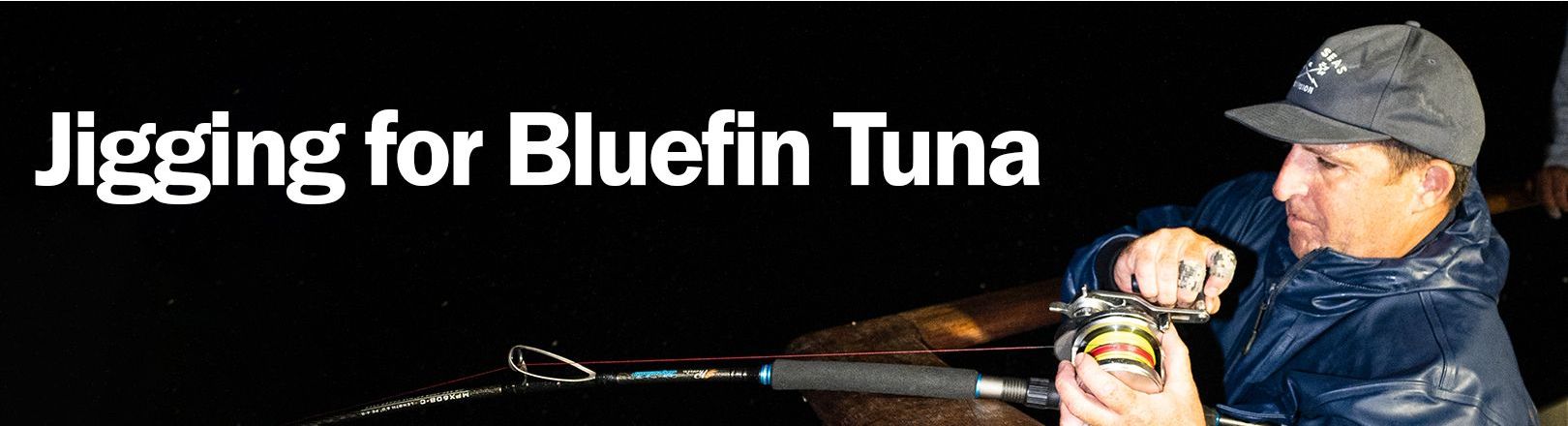Fisherman Michel Murciano jigging at night in a dark blue jacket and gray cap, gripping a rod with a silver reel spooled with red and yellow line. Text reads “Jigging for Bluefin Tuna” in large white letters against a black background.