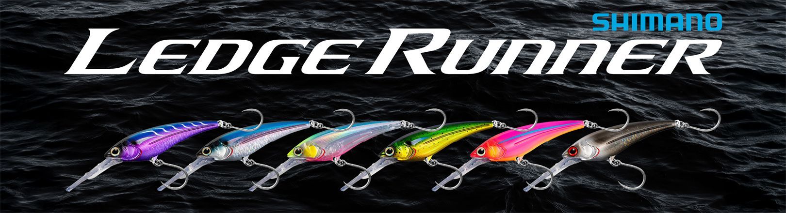 Shimano Ledge Runner Lures lined up from left to right in an assortment of colors with black water in the background.