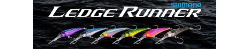 Shimano Ledge Runner Lures lined up from left to right in an assortment of colors with black water in the background.