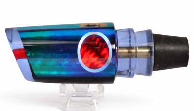 Aloha Smash Bait Baby Lure - Fish Head - #12 - Purple trolling lure with a greenish-blue reflective dichro insert, a red eye, and a black rubber hook lock attached to the rear. 