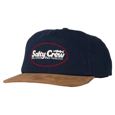 Salty Crew Fast Track Strapback Hat with navy crown and tan suede-style brim. Front patch features “Salty Crew” text with fish graphic and slogan “THRILL SEEKERS & RISK TAKERS” inside a red oval border.