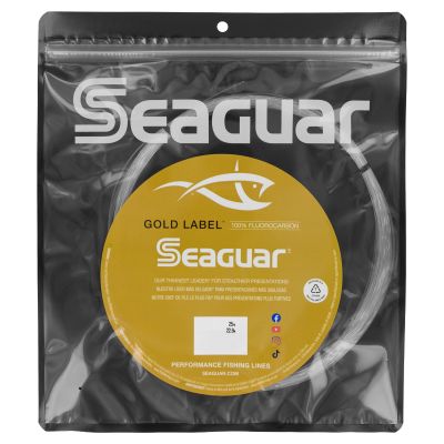 Seaguar Gold Label Fluorocarbon Leader in clear packaging with black back and gold label with "GOLD LABEL 100% FLUOROCARBON SEAGUAR" and branding. Clear line inside packaging.