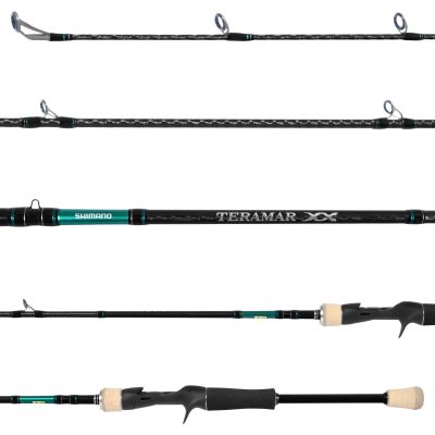 Shimano Teramar XX SW Casting Rod with black patterned blank, gray guides facing up with blue inner rings and black/green wraps, green branding section with "Shimano" in white, "Teramar XX" on blank, black trigger reel seat, cork and EVA handles.