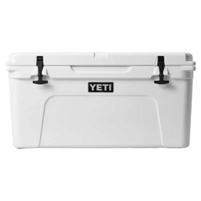 Yeti Tundra Hard Cooler - 65 - White, white hard cooler with black rubber latches and front handle, featuring text "YETI" in white-colored text on a black rectangular logo centered on the front.