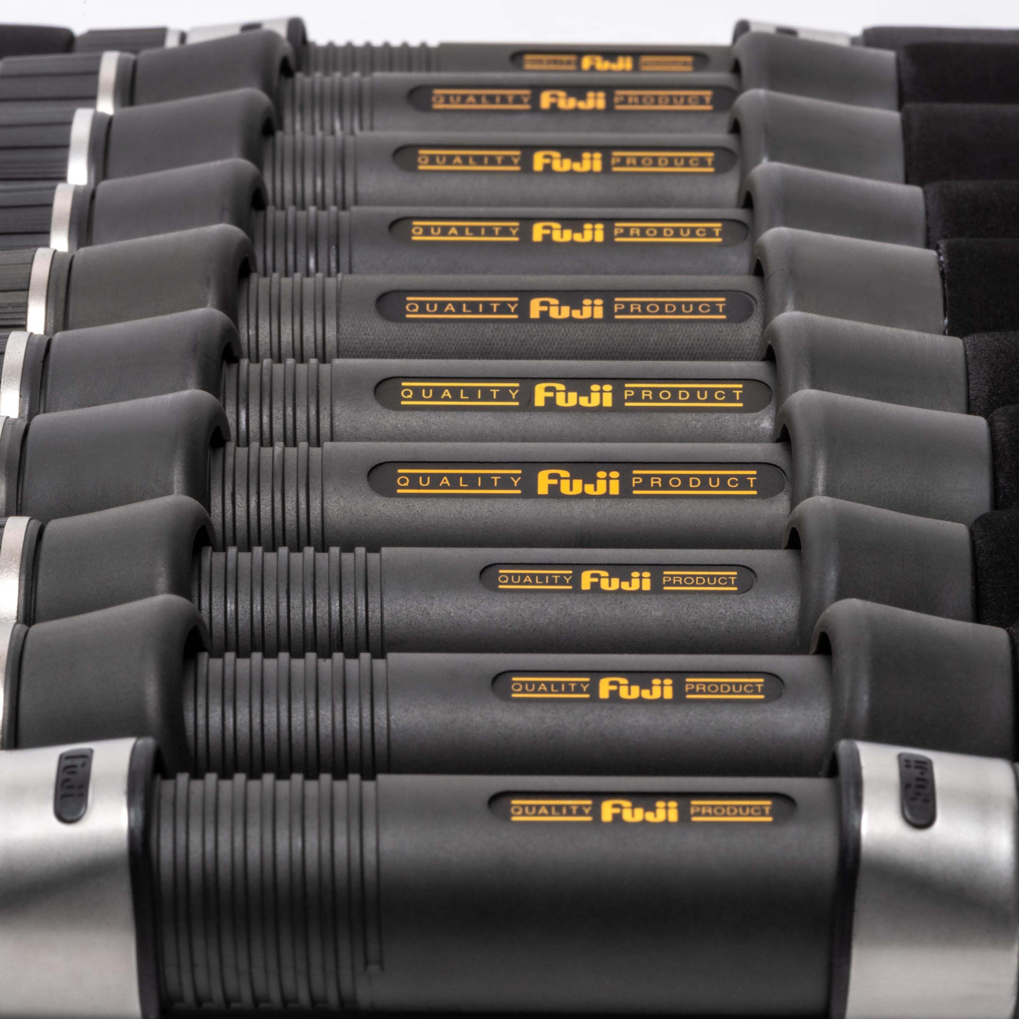 Row of Fuji reel seats with &ldquo;QUALITY Fuji PRODUCT&rdquo; logos aligned in a precise stack, showcasing black grips and silver hoods on a white background.