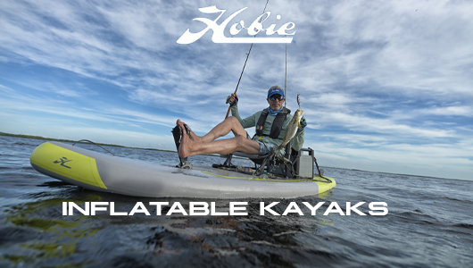 Hobie Inflatable Kayaks. Shop Now. Background shows a man fishing on a gray and yellow Hobie inflatable kayak.