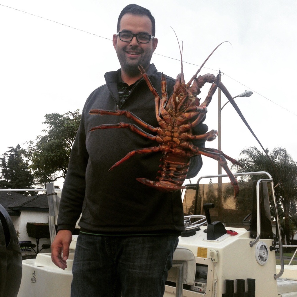 Andrew Alvarez, Customer Service Manager at Melton Tackle, smiling on a boat